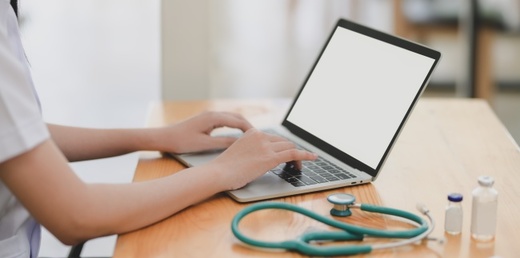 laptop-near-teal-stethoscope-in-wooden-table-3758756.jpg